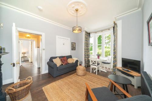 a living room with a couch and a table at The Gate Lodge in Broughty Ferry