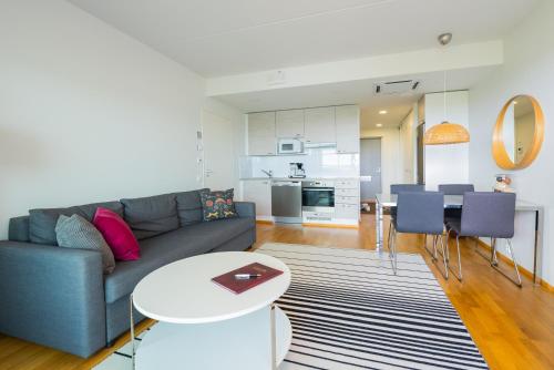 a living room with a couch and a table at Finlandia Hotel Aquarius in Uusikaupunki