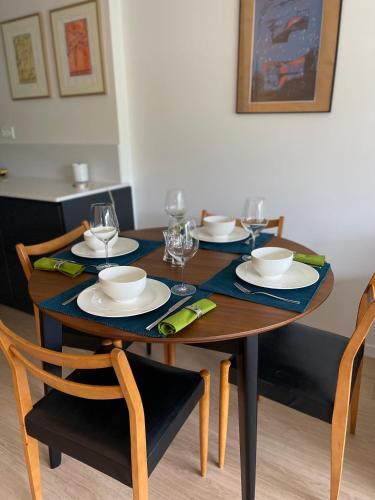 una mesa de madera con platos y copas de vino. en Petit-Saconnex, Geneva en Ginebra