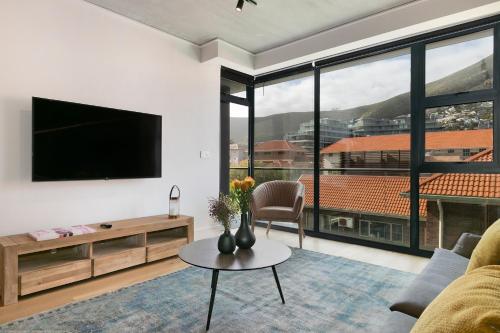 a living room with a tv and a couch at Latitude Aparthotel by Totalstay in Cape Town