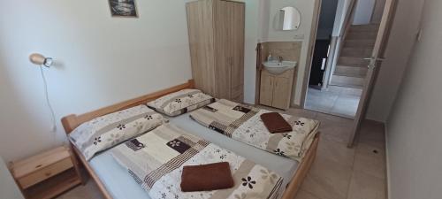 a small bedroom with two beds and a bathroom at Chata U dědka in Prostřední Bečva