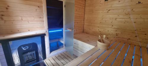 an inside view of a wooden sauna with a stove at Elitní wellness penzion U Dvou jedlí v srdci Českého ráje in Turnov