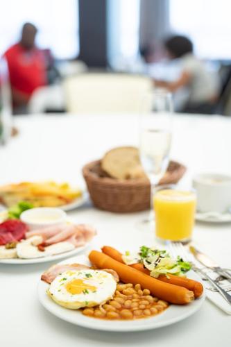 a plate of food with eggs and beans on a table at Hotel Tatra in Bratislava