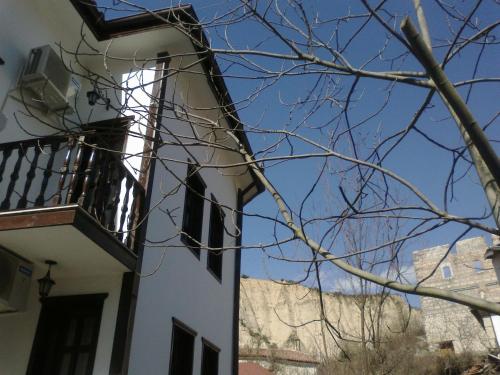a building with a balcony and a blue sky at Hotel Bolyarka in Melnik
