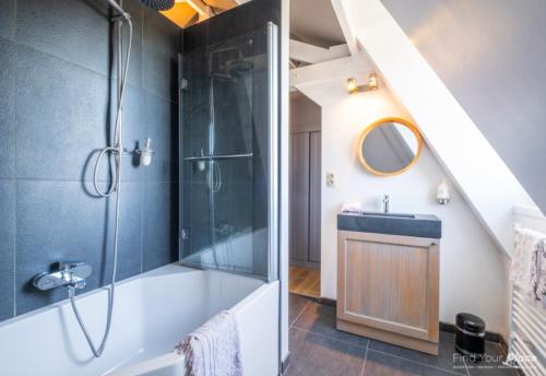 a bathroom with a shower and a sink at La Ragotière in Froyennes