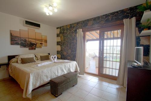 Ένα ή περισσότερα κρεβάτια σε δωμάτιο στο Villa Los Volcanes