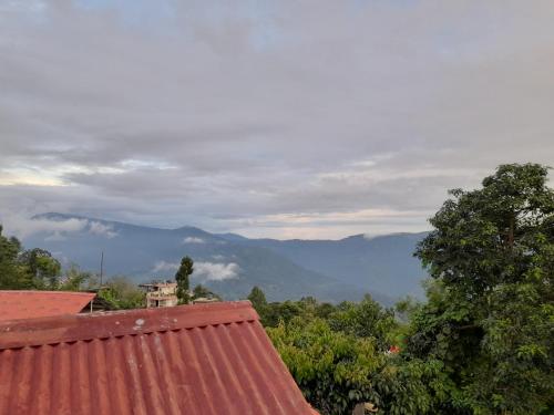 a view of the mountains from a roof of a house at Bethel homestay Delo in Kalimpong