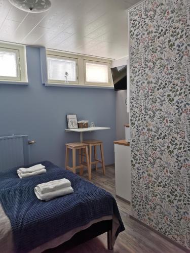 a bedroom with a bed with towels on it at Savonlinna Rentals in Savonlinna