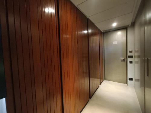 a hallway with a wooden wall and a elevator at Boulevard by Design Hotel Chennai in Chennai