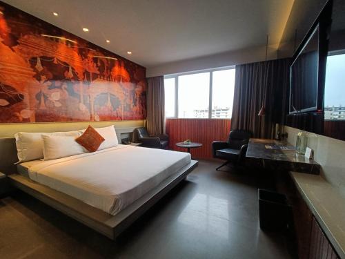 a hotel room with a bed and a desk at Boulevard by Design Hotel Chennai in Chennai