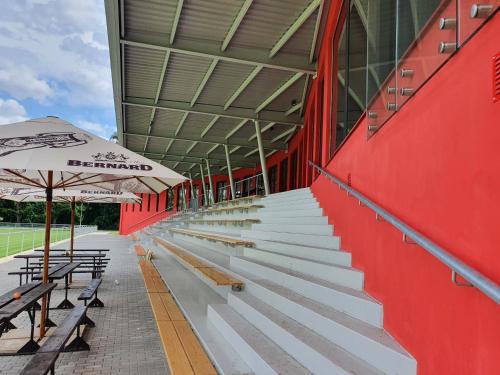 a baseball stadium with benches and an umbrella at Penzion na hřišti in Radím
