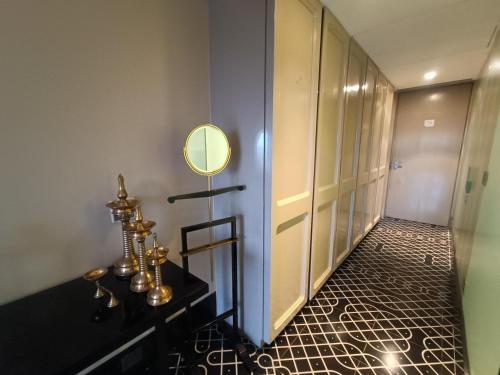 a hallway with a mirror and a dressing room at Boulevard by Design Hotel Chennai in Chennai