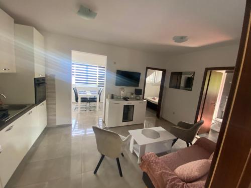 a living room with a couch and chairs and a table at GUESTHOUSE RUZA SOBRA apartments in the attic of the house in Sobra