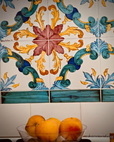 a bowl of oranges in front of a wall at Casa Maddy Amalfi Coast in Atrani