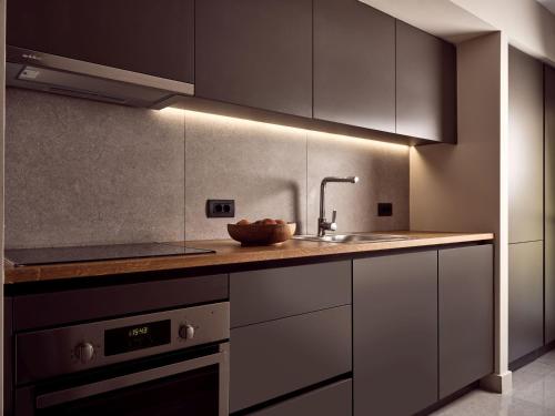 a kitchen with a sink and a counter top at Drallos Luxury Villa - Private Heated Pool & Large Groups, by ZanteWize in Alikanas