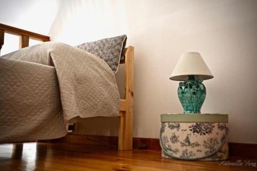 una lampada seduta su un tavolo accanto a una sedia di Casa Maddy Amalfi Coast ad Atrani
