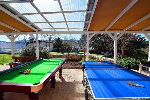 a pool table sitting under a pavillion with awning at פלאז'ה בוטיק in Peqi‘in H̱adasha