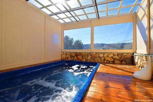 a indoor swimming pool in a room with a window at פלאז'ה בוטיק in Peqi‘in H̱adasha