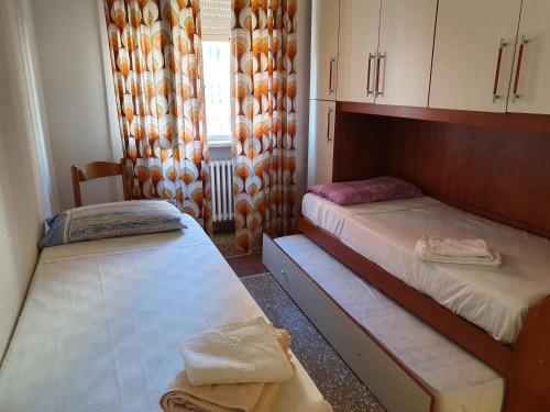 A bed or beds in a room at Central Sestri Executive BeachServices&HalfBoard