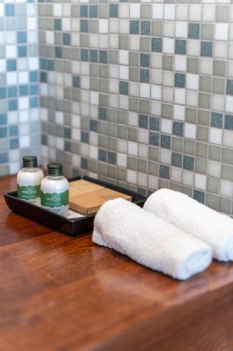 two towels on a tray on a wooden table at Napa Mermaid Hotel & Suites in Ayia Napa