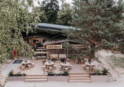 a group of tables and chairs in front of a restaurant at destinature Dorf Südeifel in Ernzen