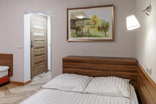 a bedroom with a bed and a picture on the wall at Leśne Patio in Katowice