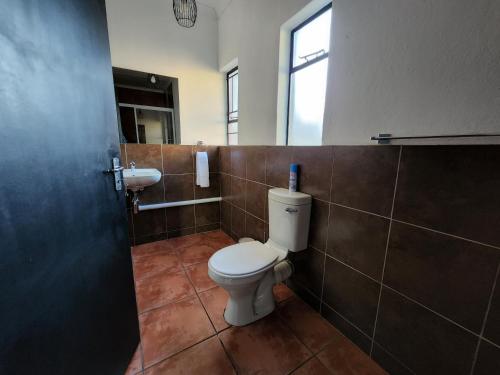 a bathroom with a toilet and a sink at Casa Tomar Unit in Mataffin