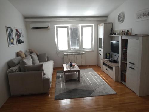 a living room with a couch and a table at Itaka - Belgrade City Center in Belgrade