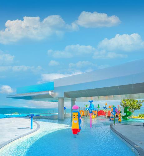 a pool with a toy in the water at a resort at Royal Wing Suites & Spa Pattaya in Pattaya South