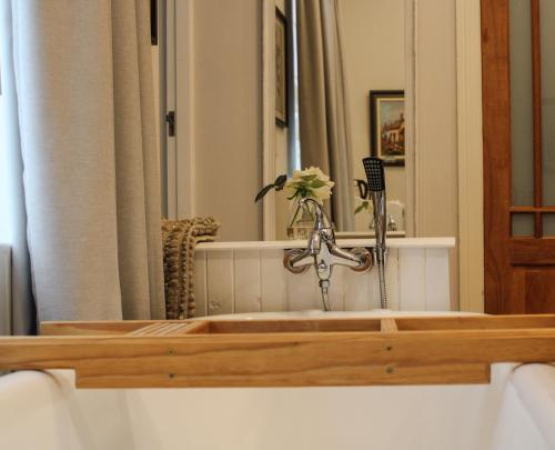a bathroom with a bath tub with a sink at Linkview House in Frankfort