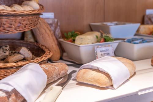 a table topped with lots of different types of bread at Napa Mermaid Hotel & Suites in Ayia Napa