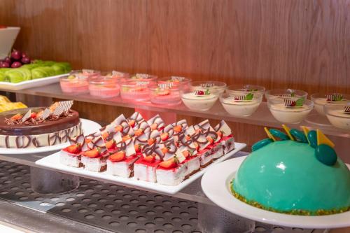 a buffet with cakes and other desserts on display at Napa Mermaid Hotel & Suites in Ayia Napa