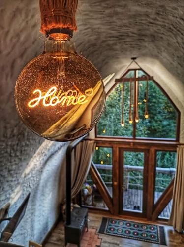 a light hanging from a ceiling in a room with a window at Căsuțele de sub Șipote in Porumbacu de Sus
