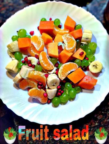 een witte plaat met groenten en fruit erop bij Vela Resort in Pushkar