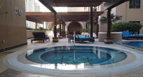 a pool in the middle of a hotel lobby at The Key - Luxury Apartment in Doha