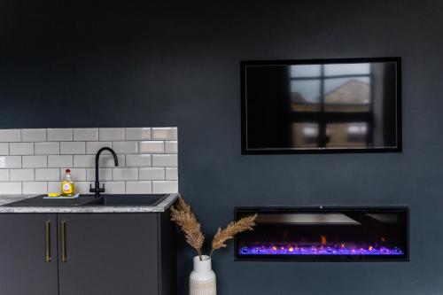 a kitchen with a fire place in the wall at Spire Accommodations Ltd in Bradford