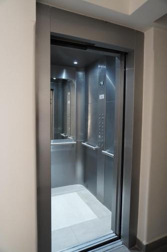 a walk in shower with a glass door at M&C Apart in Salta