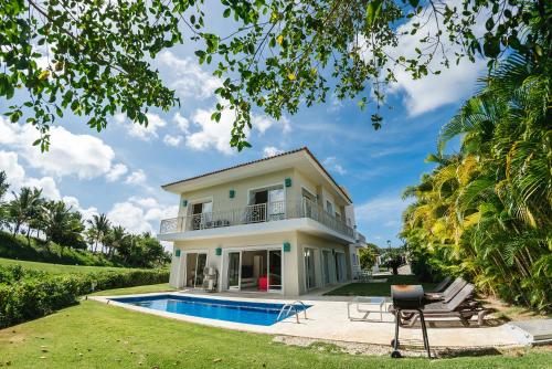 a villa with a swimming pool and a house at Luxury Private Villas with Pool Beach BBQ in Punta Cana