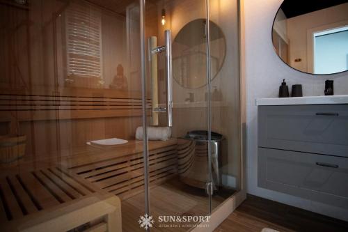 a bathroom with a glass shower with a sink at Sun&Sport apartament GÓRSKA OSTOJA +prywatna sauna in Szczyrk