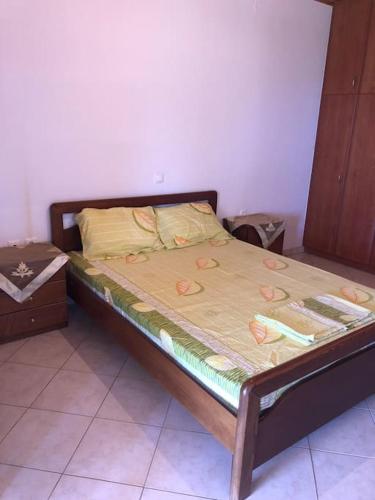 a bed with a wooden frame in a room at The best view in Zakharo