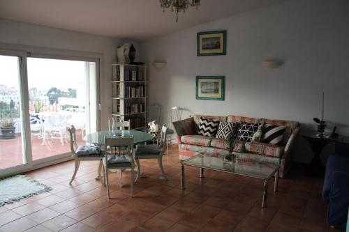 a living room with a couch and a table at Attic in Cadaques in Cadaqués