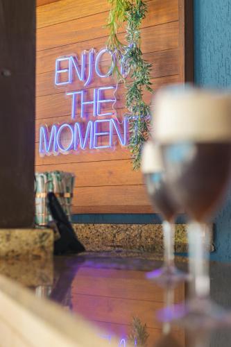 a sign that says enter the woman in front of a glass of wine at Saison Resort & Spa in Itaipava