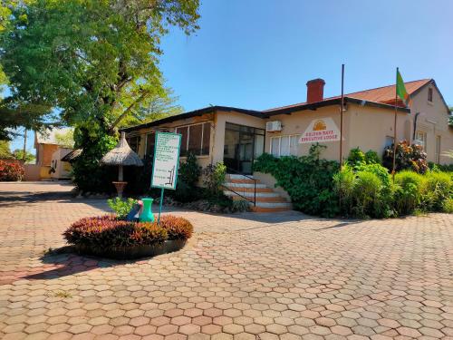 a building with a sign in front of it at Golden Days Lodge in Livingstone
