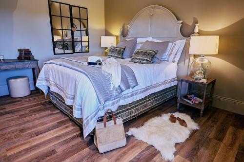 a bedroom with a large bed with a white comforter at Stable Barn 
