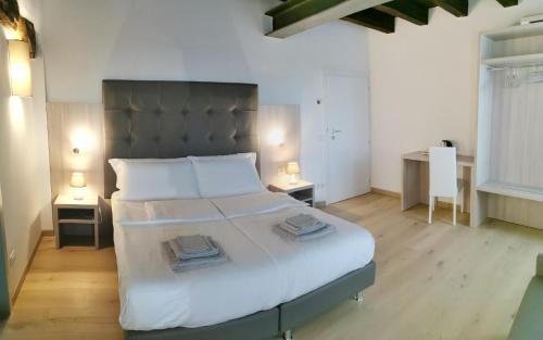 a bedroom with a large bed with two night stands at Casa BORRIERO Farmhouse in Sospirolo