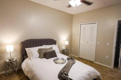 a bedroom with a large bed with white sheets at Lux 2BD 2BA minutes from the water in Pensacola