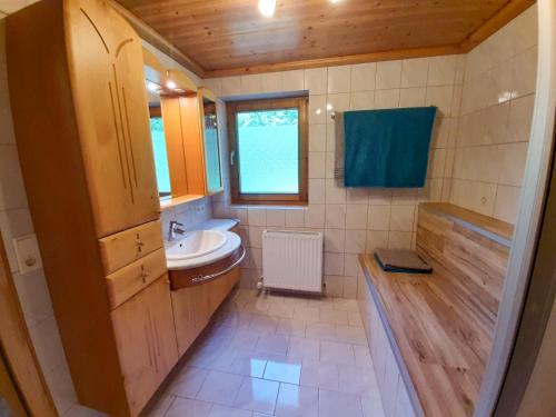a small bathroom with a sink and a toilet at Ferienwohnung Luxner in Hopfgarten im Brixental