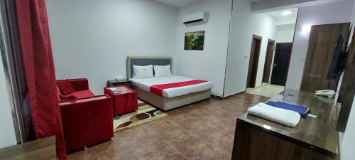 a bedroom with a bed and a chair in it at EMAN HOUSE in Salalah