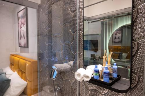a bathroom with a shower with a mirror at Natali luxury suites- mini rooms in Belgrade