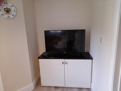 a flat screen tv sitting on top of a white cabinet at Canal View in Todmorden